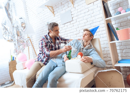 Dad helps son get up after a hard night party. 70762175