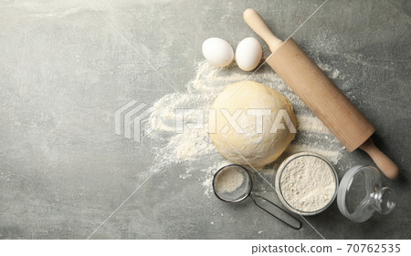 Concept for baking with dough on gray background Concept for baking with dough on gray background 70762535
