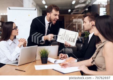 The director in a suit yells at his employees. The director in a suit yells at his employees. 70762697