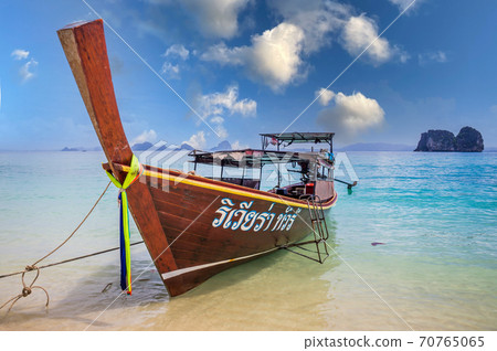 Longtail boat on beach in Thailand with blue sky 70765065