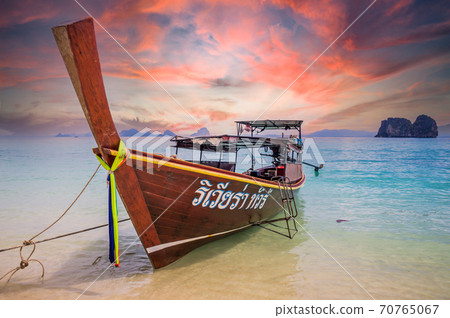 Amazing sunset over longtail boat on beach in Thailand 70765067