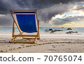 Dark clouds over deck chair at white beach in Ko Lipe, Thailand 70765074