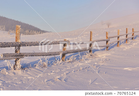 Mysterious winter landscape majestic mountains in winter. Magical winter snow covered tree. Photo greeting card. Carpathian. Ukraine Mysterious winter landscape majestic mountains in winter. Magical winter snow covered tree. Photo greeting card. Carpathian. Ukraine 70765124