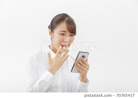 A smartphone and a woman A smartphone and a woman 70765437