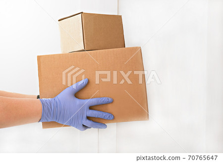 courier delivering boxes. hands holding box with food. 70765647