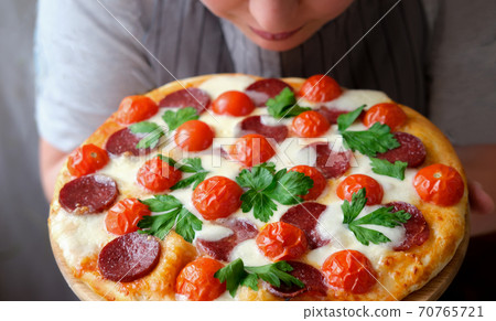 italian pizza Restaurant Menu. Pepperoni Pizza with Mozzarella cheese, salami, cherry tomatoes and cilantro.  70765721