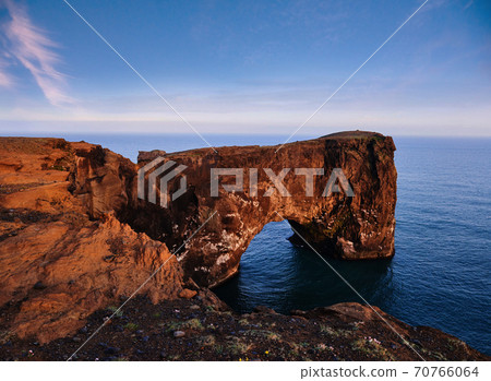 Cape Dyrholaey at southern Iceland. Altitude 120 m, and mean hill island with a door opening 70766064