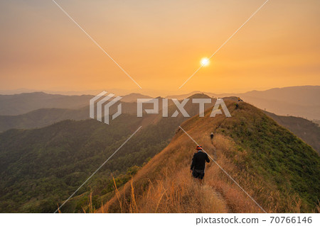traveler man hiking enjoying in the mountains with backpack at Khao Chang Puak mountain Thailand traveler man hiking enjoying in the mountains with backpack at Khao Chang Puak mountain Thailand 70766146