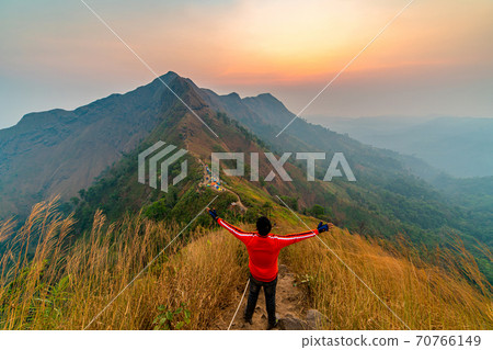 traveler man hiking enjoying in the mountains with backpack at Khao Chang Puak mountain Thailand traveler man hiking enjoying in the mountains with backpack at Khao Chang Puak mountain Thailand 70766149