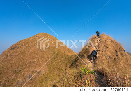 traveler man hiking enjoying in the mountains with backpack at Khao Chang Puak mountain Thailand traveler man hiking enjoying in the mountains with backpack at Khao Chang Puak mountain Thailand 70766154