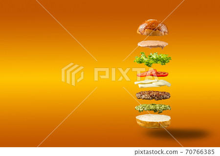 Floating burger ingredients on orange background Floating burger ingredients on orange background 70766385