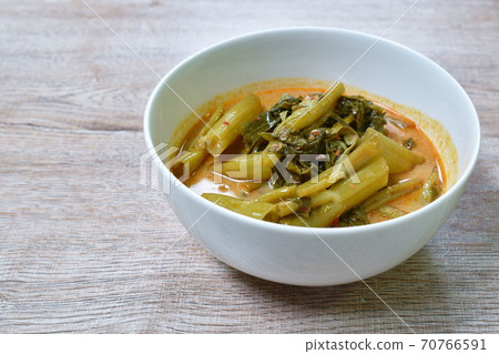 spicy boiled morning glory with fat pork in coconut milk curry or Kaeng The Po Thai food on bowl spicy boiled morning glory with fat pork in coconut milk curry or Kaeng The Po Thai food on bowl 70766591
