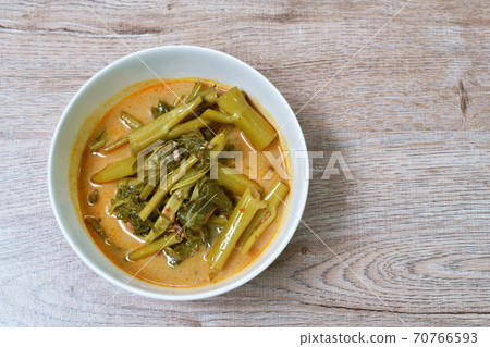 spicy boiled morning glory with fat pork in coconut milk curry or Kaeng The Po Thai food on bowl spicy boiled morning glory with fat pork in coconut milk curry or Kaeng The Po Thai food on bowl 70766593