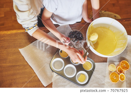 Making muffins and molding in molds Making muffins and molding in molds 70767925