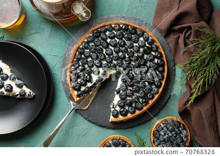 Concept of tasty lunch with blueberry pie on green background Concept of tasty lunch with blueberry pie on green background 70768328