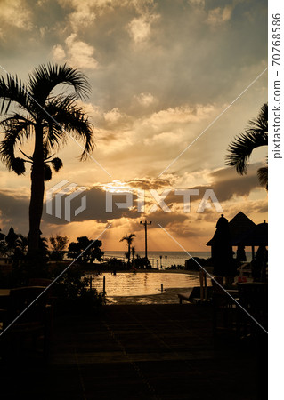 Sunset seen from the poolside of a tropical resort 70768586