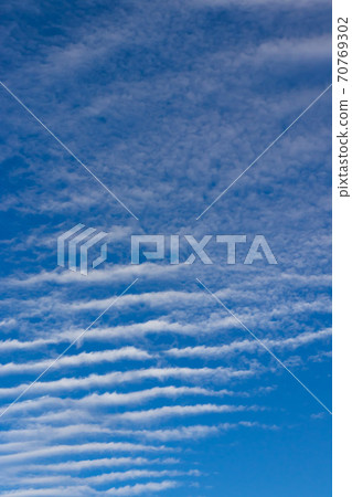 Ribbed clouds on a blue sky background Ribbed clouds on a blue sky background 70769302