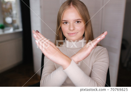 Beautiful blond hair woman crossed arms. Woman in beauty studio 70769825