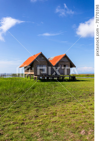 Twin old house on wetland at Talay Noi lake, Phatthalung Province, Thailand Twin old house on wetland at Talay Noi lake, Phatthalung Province, Thailand 70770398