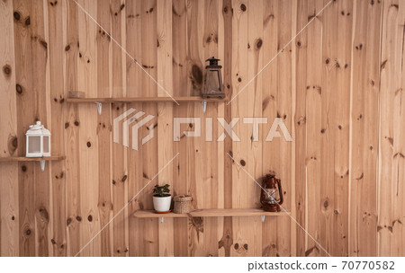Old lamps or Retro lantern and pot with ivy plant on shelves at wooden wall. Front view. Abstract background or wallpaper Old lamps or Retro lantern and pot with ivy plant on shelves at wooden wall. Front view. Abstract background or wallpaper 70770582