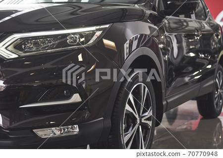 The headlights and the hood of a black luxury car The headlights and the hood of a black luxury car 70770948