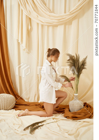 young sensual woman in studio interior 70771844