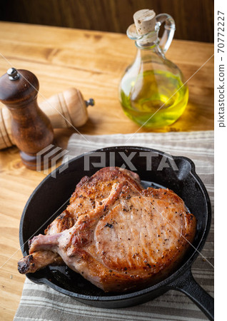 pan fried pork chop in skillet pan 70772227