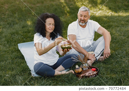 Happy elderly senior couple doing hindu practice Happy elderly senior couple doing hindu practice 70772484