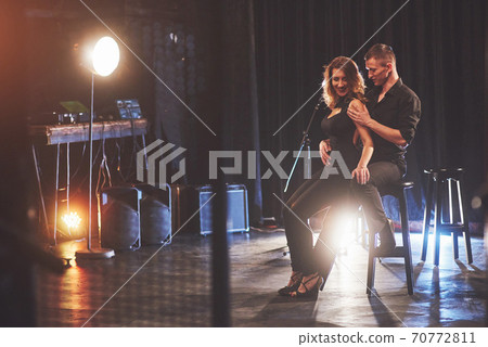 Skillful dancers performing in the dark room under the light 70772811