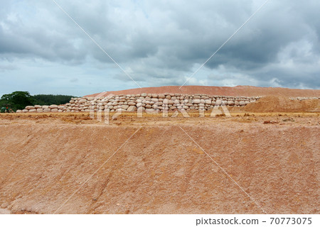 Stone boulders are stacked on the ground and used as retaining walls. It acts to resist soil erosion caused by rain. Stone boulders are stacked on the ground and used as retaining walls. It acts to resist soil erosion caused by rain. 70773075