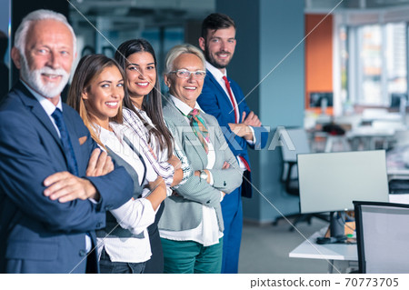 Businessteam in office, Happy Senior Businessman in His Office is standing in front of their team. Businessteam in office, Happy Senior Businessman in His Office is standing in front of their team. 70773705