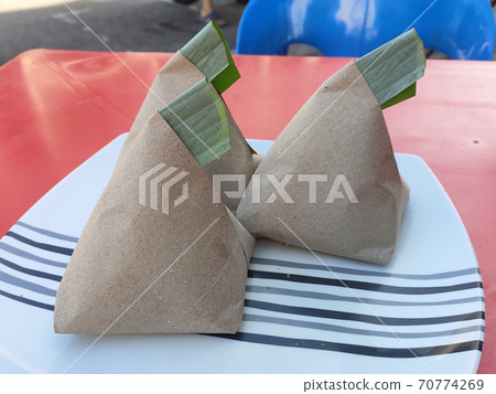 Nasi lemak. Is a signature food in Malaysia. Often eaten as breakfast. Nasi lemak is usually served with sambal, eggs and anchovies. Nasi lemak. Is a signature food in Malaysia. Often eaten as breakfast. Nasi lemak is usually served with sambal, eggs and anchovies. 70774269