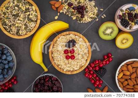 Group Fruits Breakfast with bread Whole grains and nuts, yogurt mix with Cherry , banana, avocado in the wooden table. Breakfast for Health and Diet concept 70774388