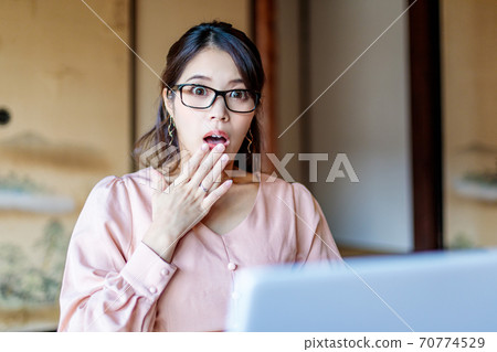 A woman who lives in the country and works using a computer A woman who lives in the country and works using a computer 70774529