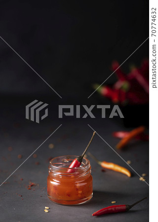 hot chili sauce in small jars 70774632