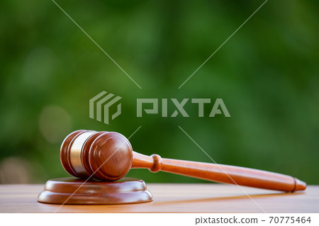Old wood Judge hammer in close-up the table wood background, Used for adjudication and Justice. Old wood Judge hammer in close-up the table wood background, Used for adjudication and Justice. 70775464