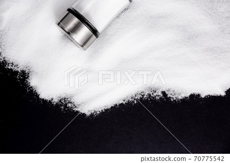 White sea salt for cooking in a small glass bottle. On the salt background, write stop. Concept for health White sea salt for cooking in a small glass bottle. On the salt background, write stop. Concept for health 70775542