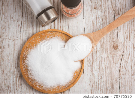 White sea salt for cooking food in Small glass bottles, wooden spoons, and trays on Old wooden table Background. White sea salt for cooking food in Small glass bottles, wooden spoons, and trays on Old wooden table Background. 70775550