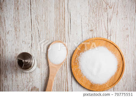 White sea salt for cooking food in Small glass bottles, wooden spoons, and trays on Old wooden table Background. White sea salt for cooking food in Small glass bottles, wooden spoons, and trays on Old wooden table Background. 70775551