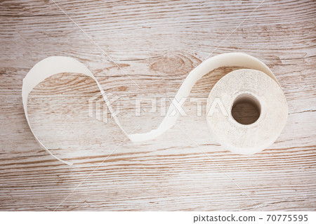 A large white toilet paper roll for use in bathrooms or kitchens, used for cleaning dirt in the bathroom background. A large white toilet paper roll for use in bathrooms or kitchens, used for cleaning dirt in the bathroom background. 70775595
