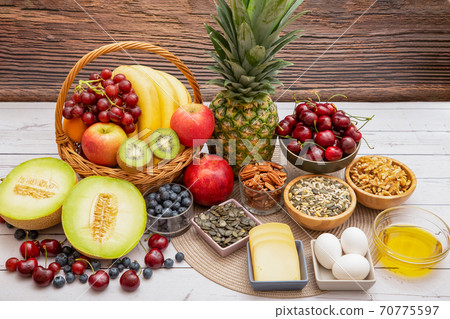 Group Nuts put on the bowl and fruit is banana,pineapple and grape is food healthy on the wooden table background 70775597