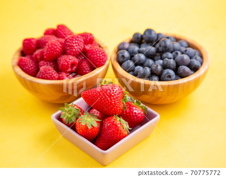 Group berry mix - strawberries, raspberries and blueberries of nature fruit in wood bowl, healthy food for diet. Group berry mix - strawberries, raspberries and blueberries of nature fruit in wood bowl, healthy food for diet. 70775772