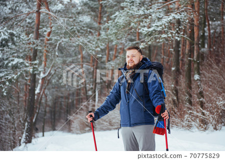Man Traveler with backpack hiking Travel Lifestyle adventure concept active vacations outdoor. Beautiful landscape forest 70775829