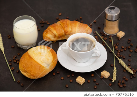 Breakfast in the morning with black coffee cup with bread with Croissant and fruit on the black background. Breakfast in the morning with black coffee cup with bread with Croissant and fruit on the black background. 70776110