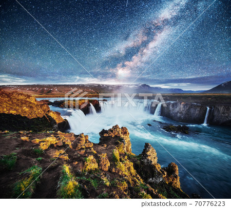 Hodafoss very beautiful Icelandic waterfall. It is located in the north near Lake Myvatn and the Ring Road. Fantastic starry sky and the milky way 70776223