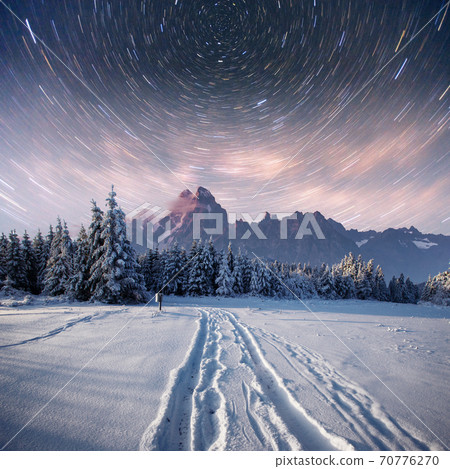 starry sky in winter snowy night. fantastic milky way in the New Year's Eve. In anticipation of the holiday. Dramatic scene. Carpathian. Ukraine 70776270