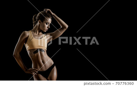 young fitness woman on black background young fitness woman on black background 70776360