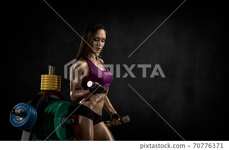 young fitness woman with dumbbells young fitness woman with dumbbells 70776371