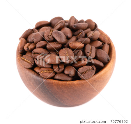 Coffee beans in wooden bowl isolated on white background. Roasted arabica coffee beans. Coffee beans in wooden bowl isolated on white background. Roasted arabica coffee beans. 70776592