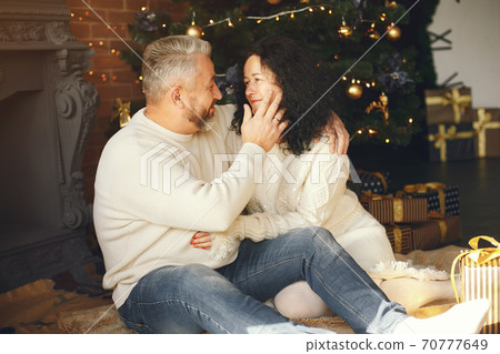 Senior couple with gifts near the Christmas tree Senior couple with gifts near the Christmas tree 70777649